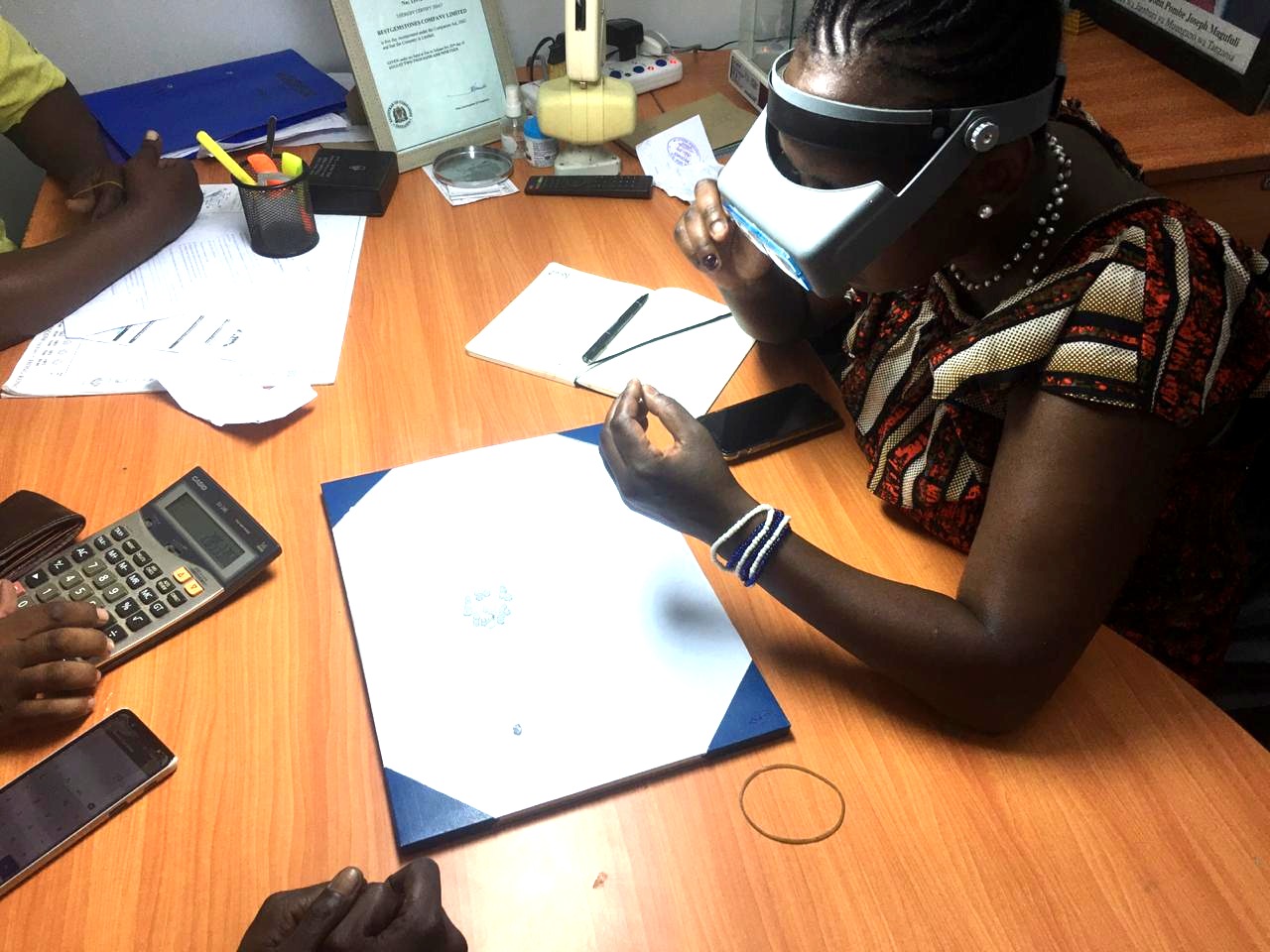 Winnie Yula Mwania examining diamond material during a 2021 field assessment in the Democratic Republic of the Congo